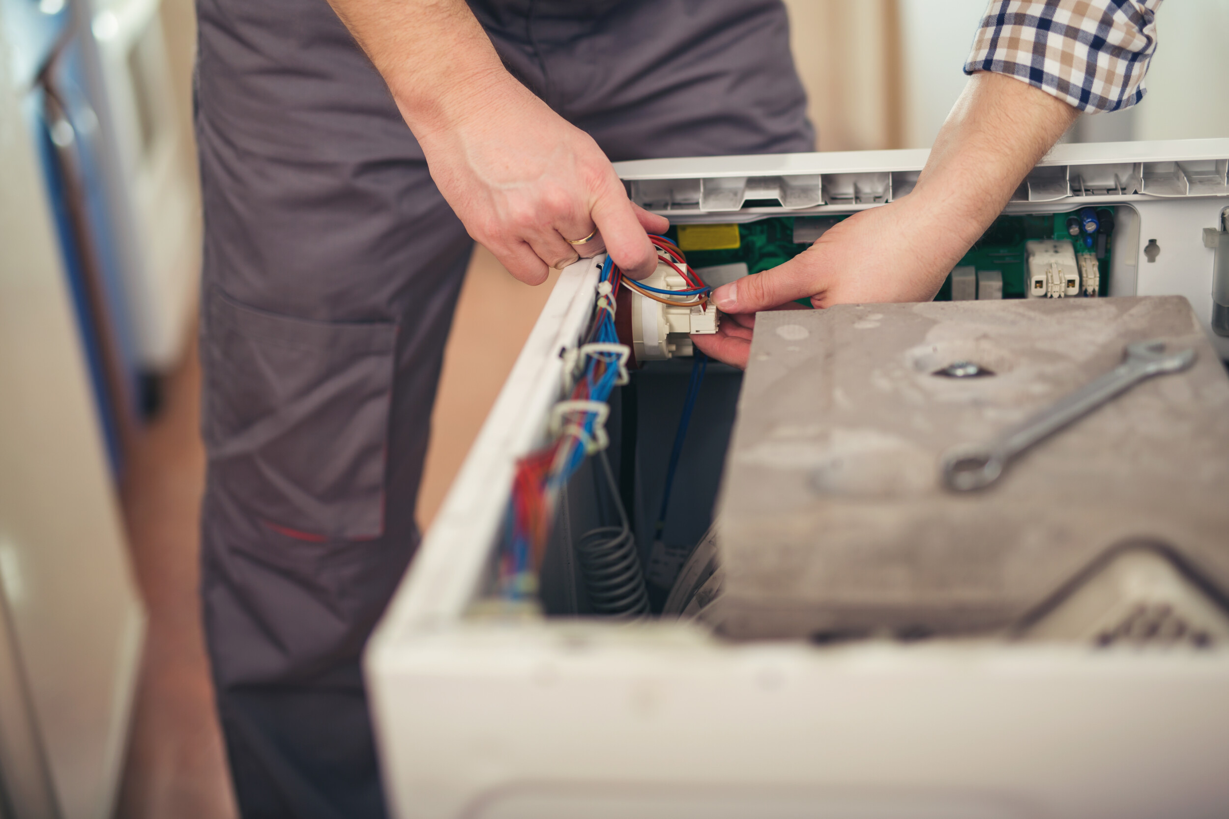 Technician repairing a washing machine Oven Repairs in Ringwood